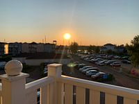 Sunset behind parking lot.