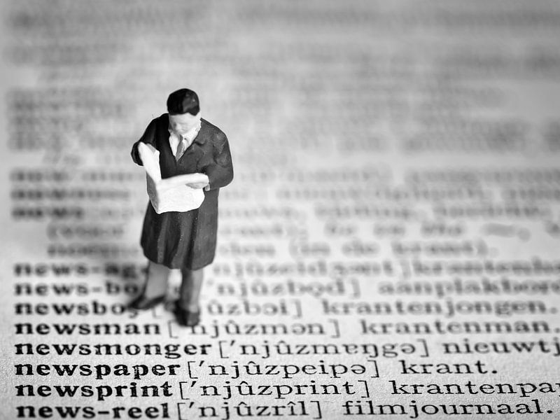 Man with newspaper #4 (black and white) by Lex Schulte