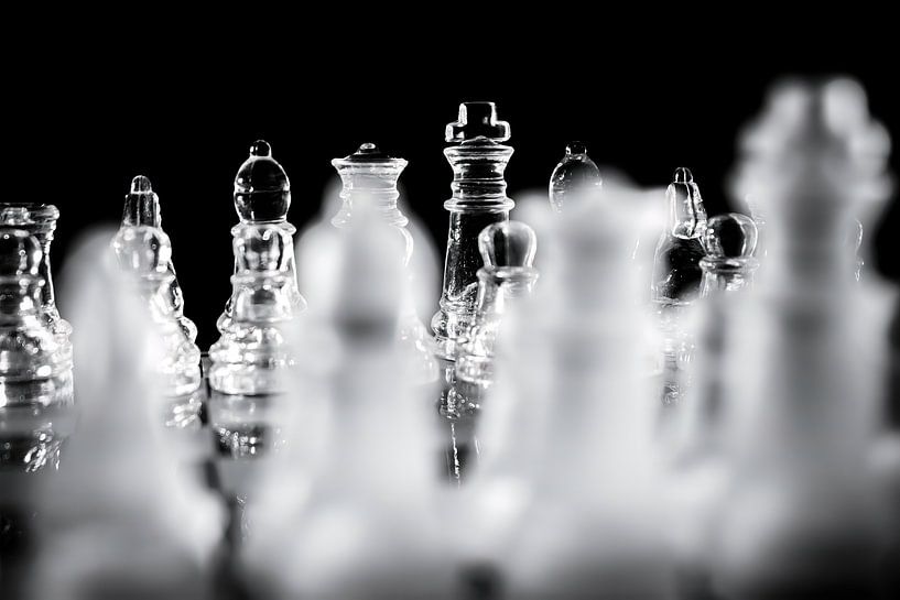 Black and White Glass Chess Pieces on Chessboard by Andreea Eva Herczegh