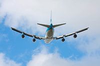 Departing Boeing 747 heading into the clouds