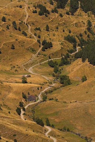 A road runs through a valley in the Pyrenees by Paul Wendels