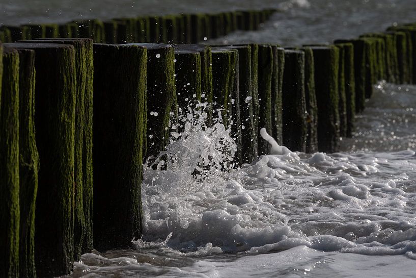 Wave splashes against the breakwaters on the coast of Zeeland by Marjolijn van den Berg