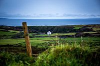 White Irish cottage sheltered from the Atlantic Ocean