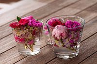 Beautiful Pretty fresh mixed flowers arranged in glass vases on wooden table