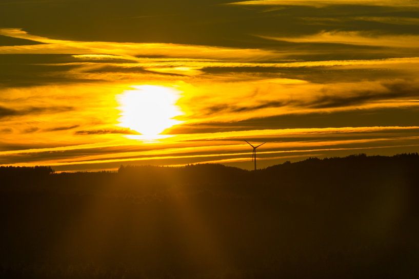 Germany, Orange fire sunset sky behind black forest horizon by adventure-photos