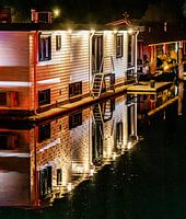 Houseboat with lighting and reflection at night