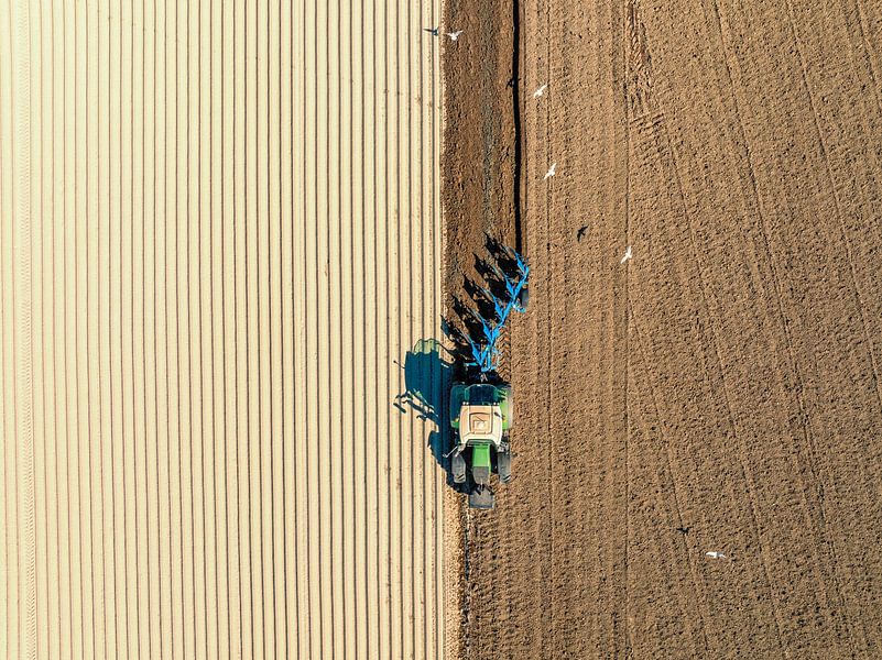 Tractor preparing the soil for planting crops by Sjoerd van der Wal Photography