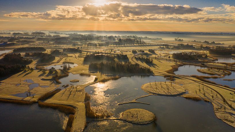 Morning sun over the hoarfrost-covered landscape. by Menno Schaefer