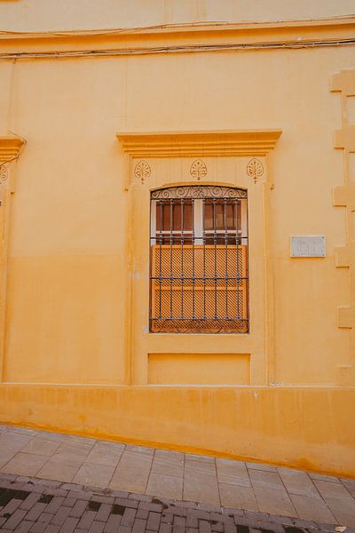 Warm yellow wall in street Almeria Spain by sonja koning