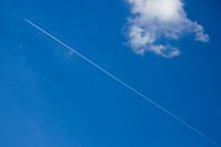 Aeroplane stripe in blue cloud sky
