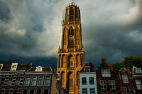 Cathedral tower under thunderstorm sky.