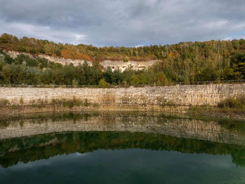 Lake with water reflections at former limestone quarry by Robin Jongerden