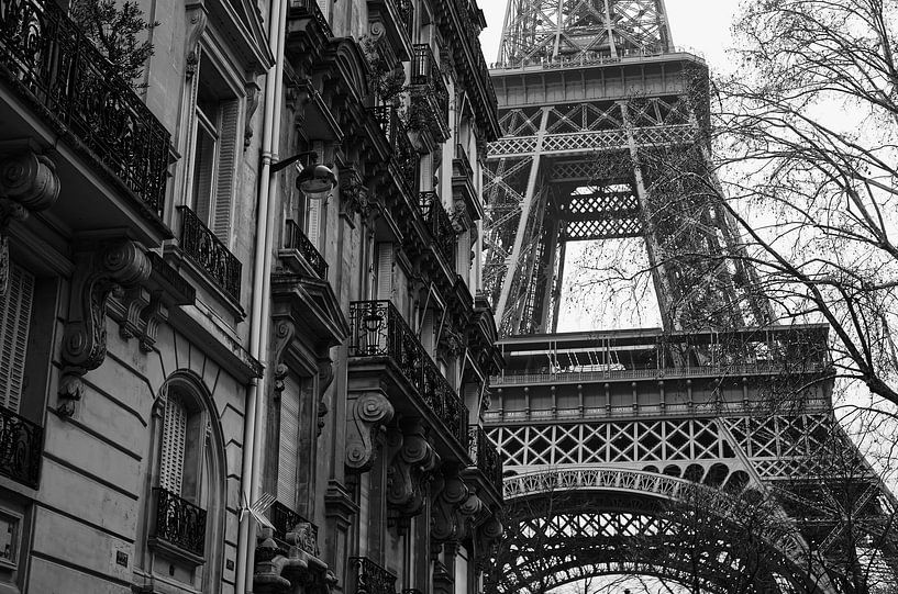Eifel Tower in Paris from a side street in black and white by Robert Jan Smit