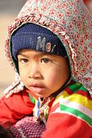 Child hanging on mothers back