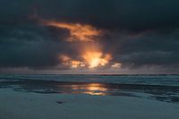 Sunset with a dark cloudy sky near Terschelling