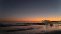 Evening romance with a crescent moon over the Santa Monica Pier