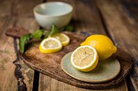 Wooden cutting board with lemons
