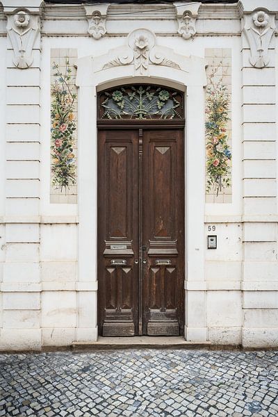 Portuguese door with floral decoration in Coimbra by Paula Romein