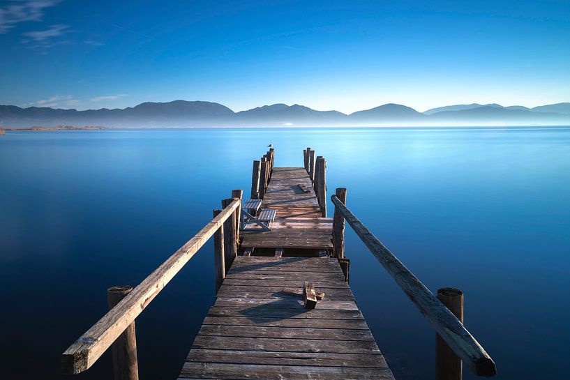 Wooden pier at sunrise. Lake Massaciuccoli, Tuscany, Italy by Stefano Orazzini