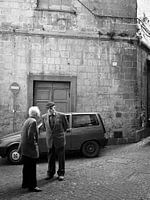 Typical italian street scene with old men in monochrome