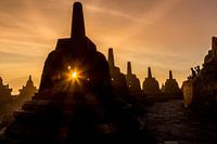 Borobudur at sunrise - sun through stupa