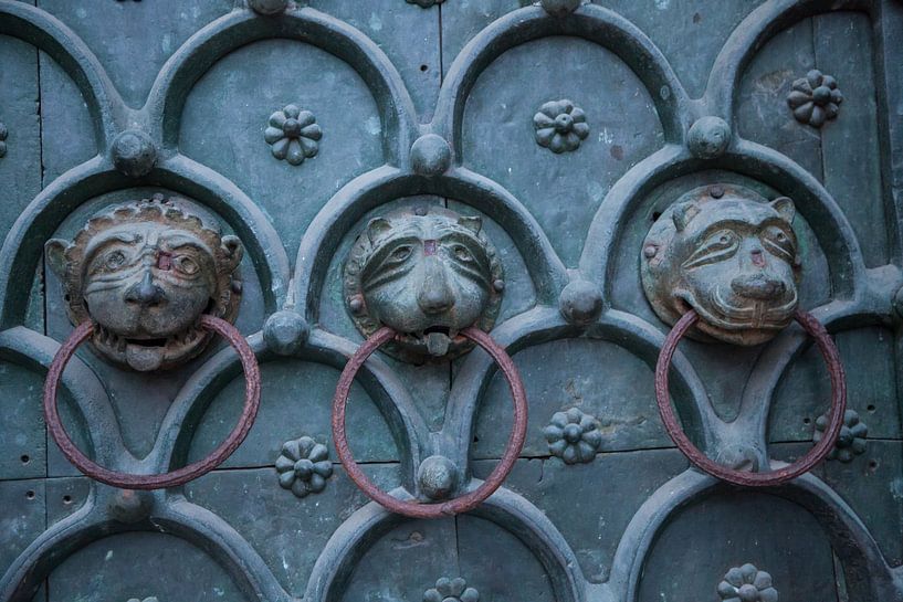 Knockers on the door of San Marco Basilica in Venice, Italy with bronze lion heads by Joost Adriaanse