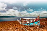 Old and Weathered Traditional Small Boat in Seixal Bay Amid Portugal Coastal Seascape