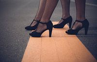Women legs with high heels on a street