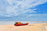 Rotes Fischerboot am Strand