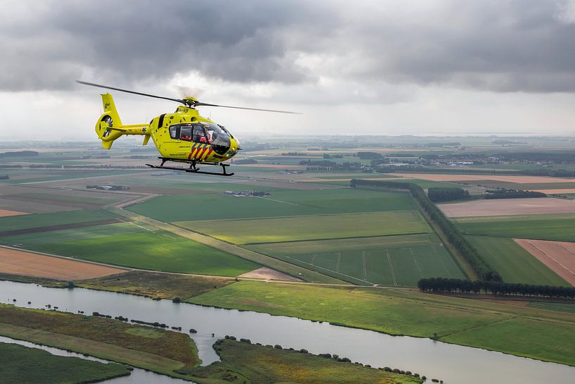 Trauma helicopter above typical Dutch landscape by Jimmy van Drunen
