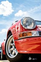 Red Porsche nine-eleven looks up into the sky in the sunshine