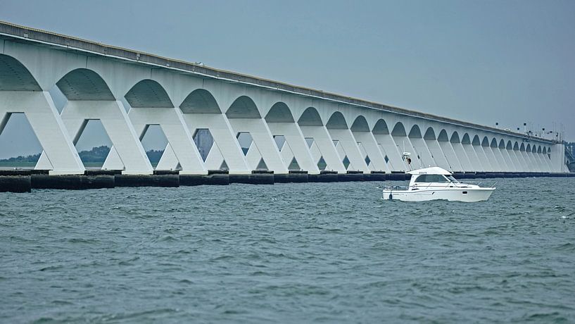 Ein kleines Motorboot ist gerade unter der Zeeland-Brücke hindurchgefahren von Gert van Santen