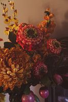 Still life with warm flowers and fruit