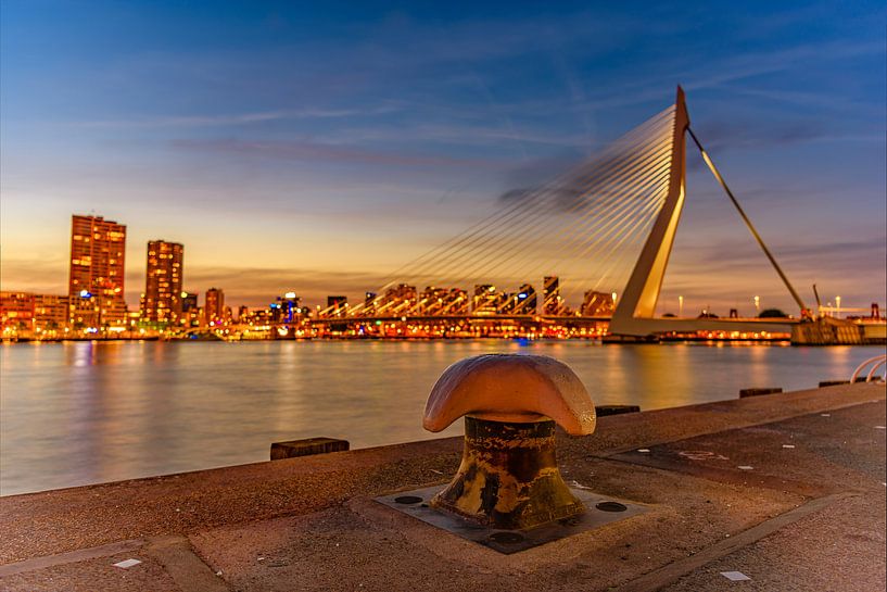Bollard close-up with Rotterdam cityscape and the Erasmus bridge in the background by Gea Gaetani d'Aragona