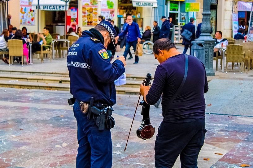 Arrested street musician in Valencia by Scarlett van Kakerken