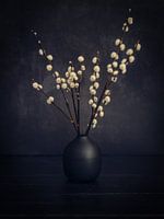 Cotton balls in a black vase