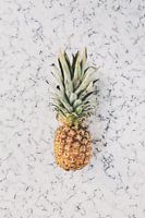 Pineapple on white marble