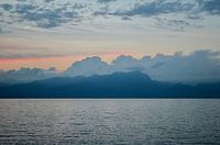 Sunset, lake, mountains and clouds.