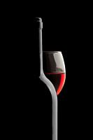 Elegant Wine Bottle and Red Wine Glass on a Black Background #1