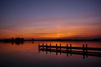 Zonsondergang / A dock at a river when the sun comes up.