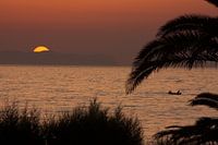 vissers bij zonsondergang