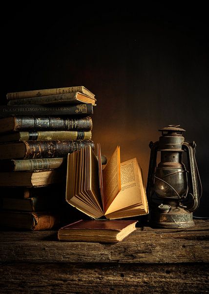 Still life with old books and a lantern by bob van den berg