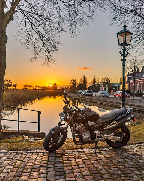 Motorcycle at picturesque harbour at sunset by RH Fotografie