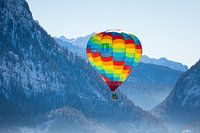 Hot air balloons adorn the sky over a snowy Inzell in Germany