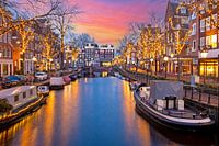 Stadtbild von Amsterdam zu Weihnachten an der Spiegelgracht in den Niederlanden bei Sonnenuntergang