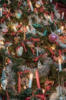 Beautiful antique baubles and candles in a unique crib setting with a homely atmosphere.