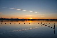 Sunrise at a lake and buoys.