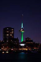 A green-lit Euromast in the evening