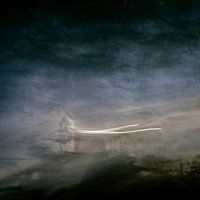 Where does the light come from in this foggy landscape?