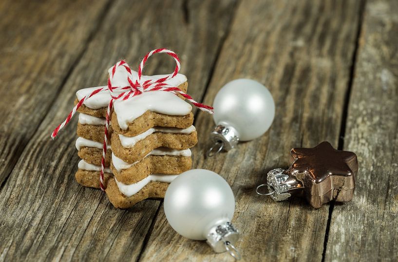 Stack of christmas cookies gift with decorations on wood background by Alex Winter